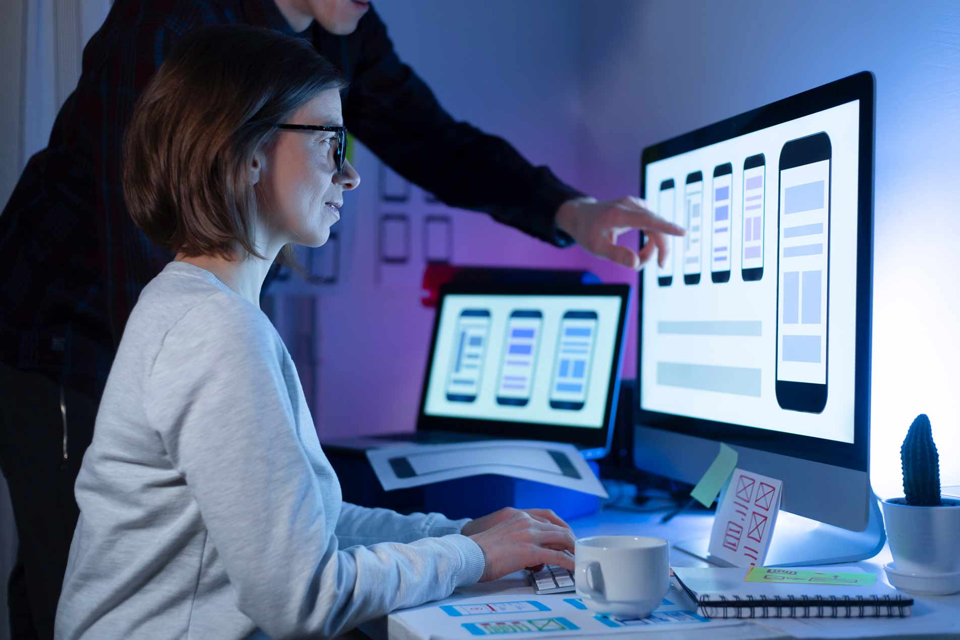 Woman developer looking at a design of a mobile phone.