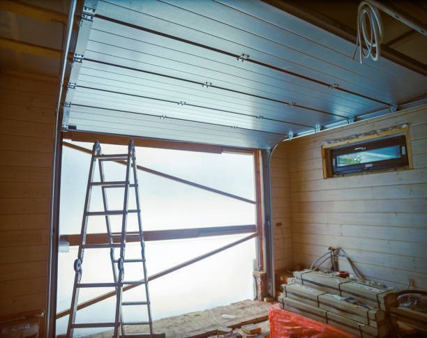 A ladder is sitting in a garage next to a garage door.