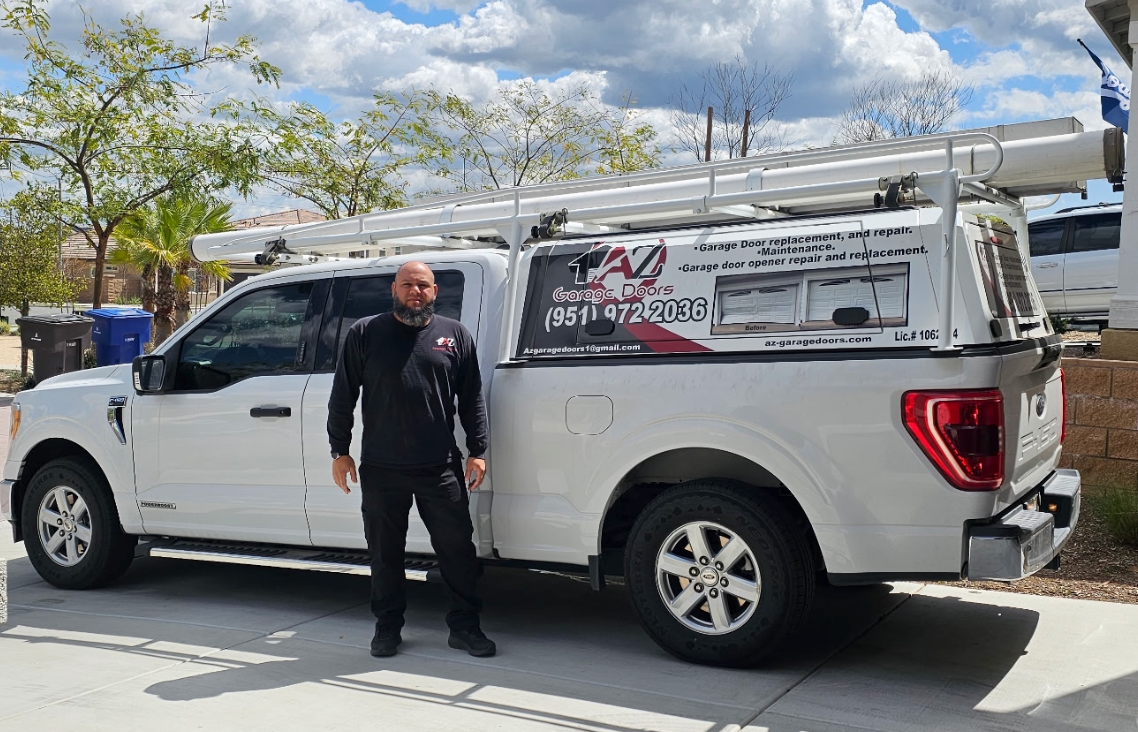 A man is standing in front of a white truck.