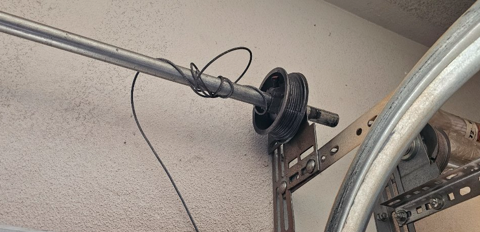 A garage with a barbell and a bicycle in it.