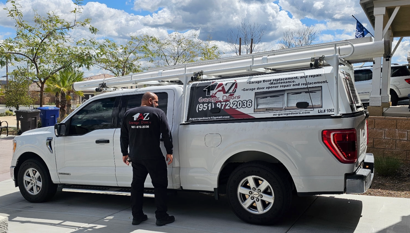 A man is standing next to a white truck.