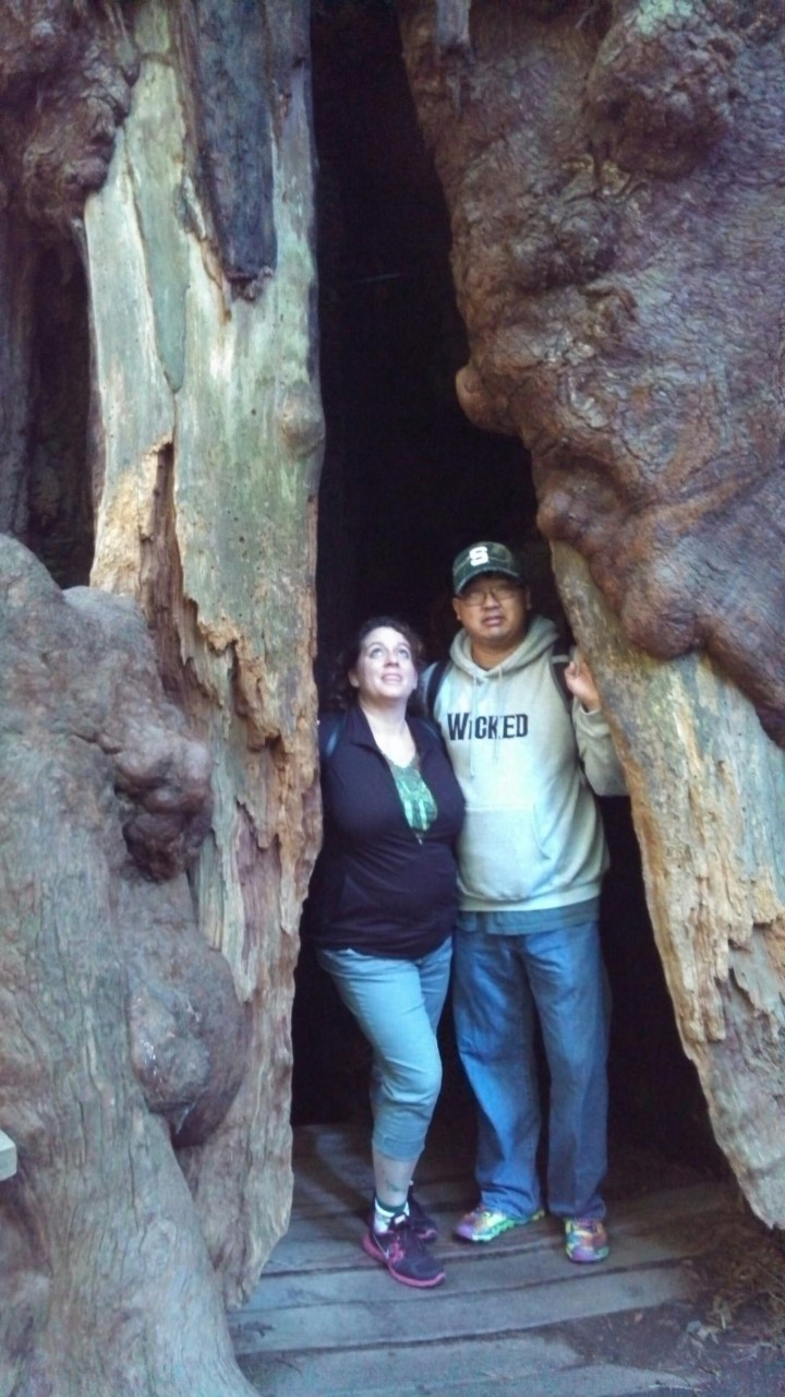 A man and a woman are standing in a cave.