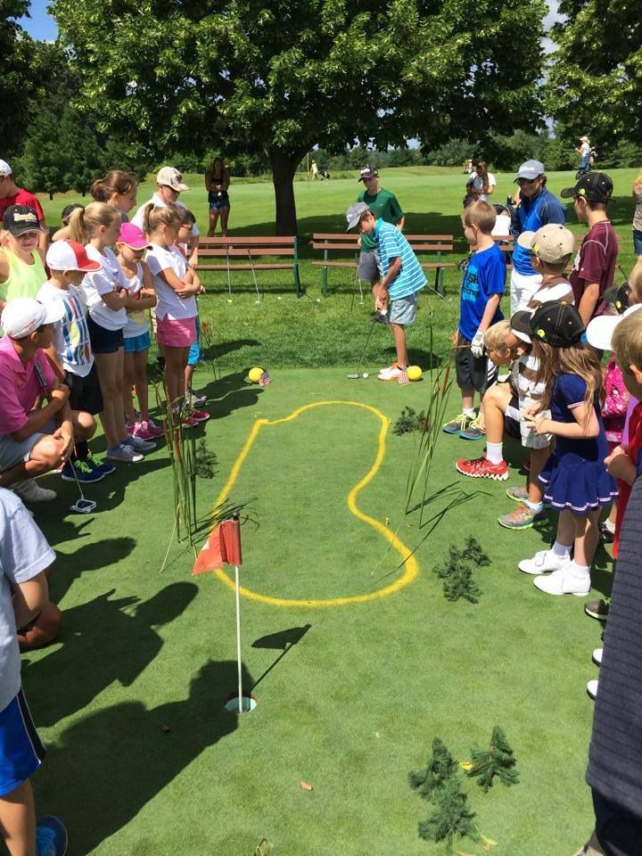 A group of children are playing a game of golf