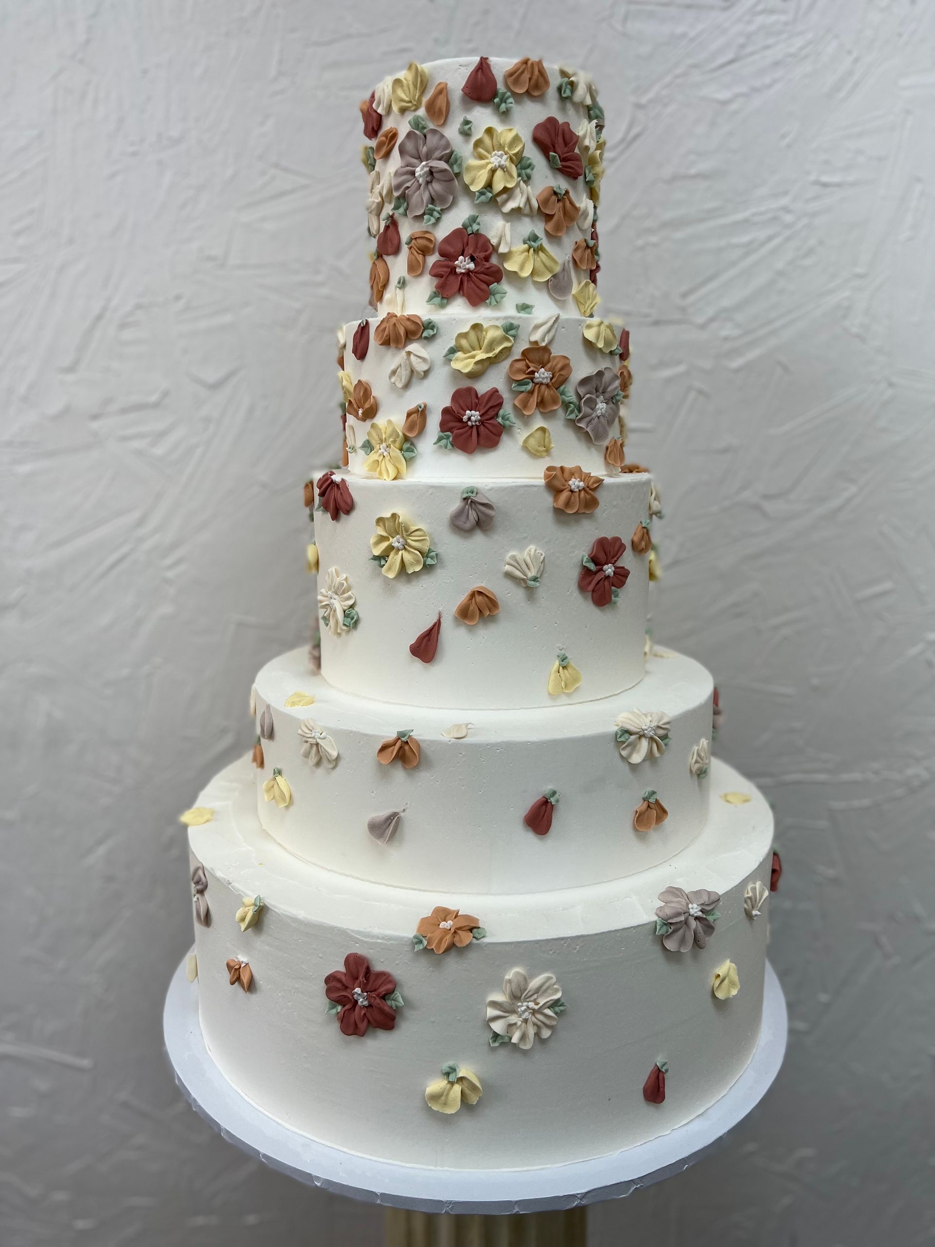 a white cake with flowers on top of it