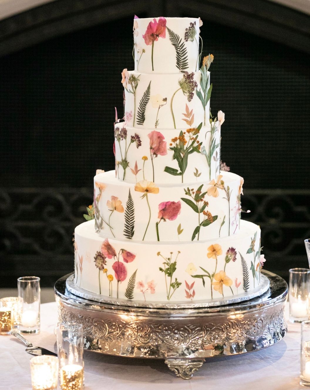 a wedding cake with flowers on it is sitting on a table .