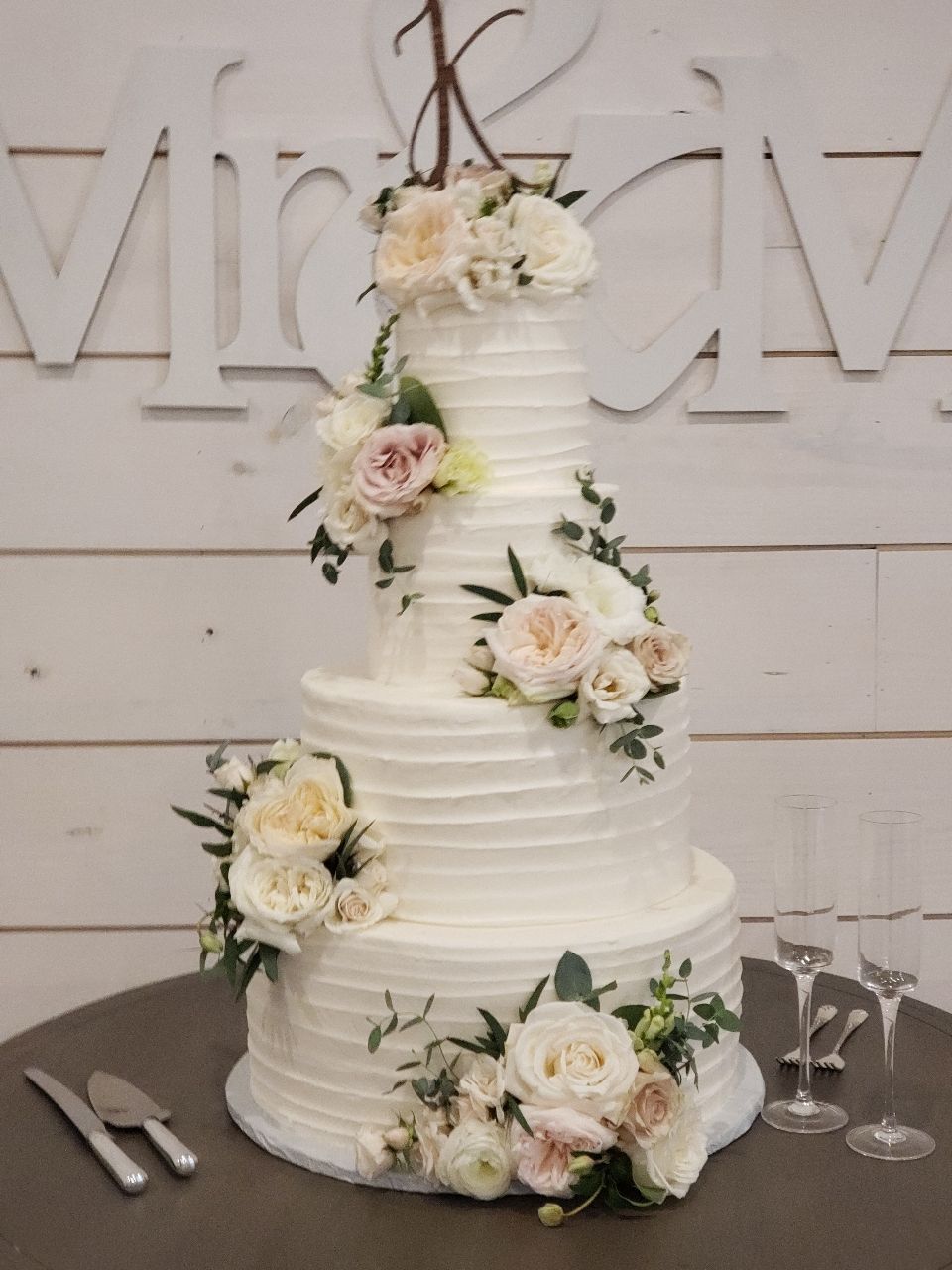 a wedding cake with flowers on it is on a table
