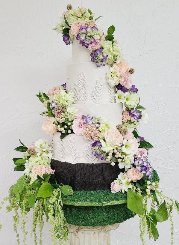 a wedding cake with flowers on top of it
