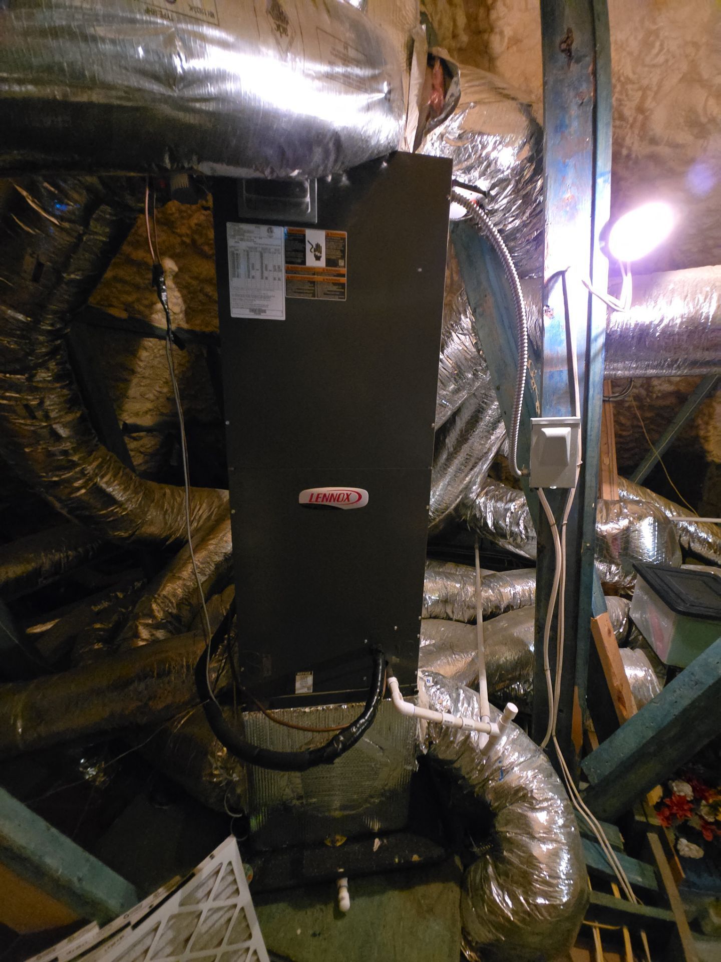A lennox air conditioner is hanging from the ceiling of a building