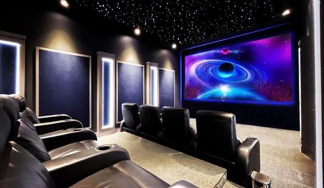 A home theater with a large screen and a lot of seats.