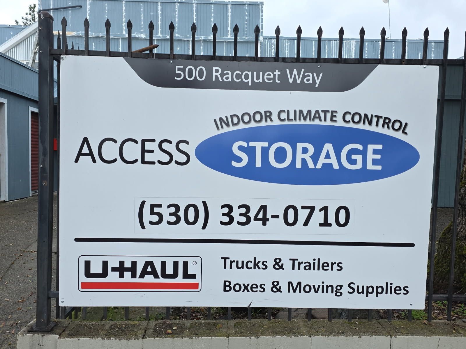 Sign for Access Storage, offering indoor climate control, at 500 Racquet Way. Includes a U-Haul logo with services.