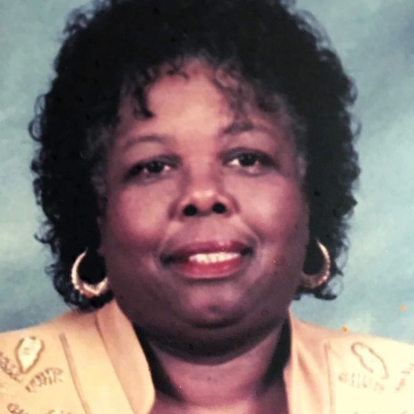 A shelf filled with lots of bottles of hair products.