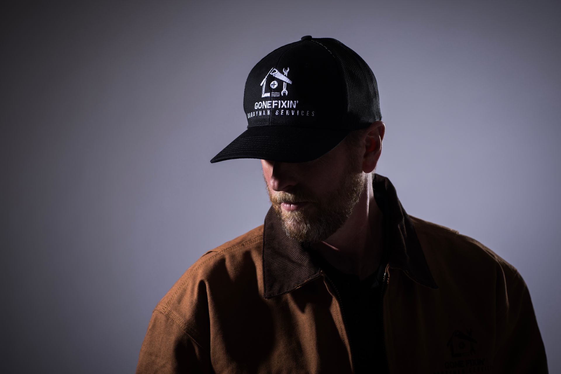 Close-up of a brown jacket with a logo that says 