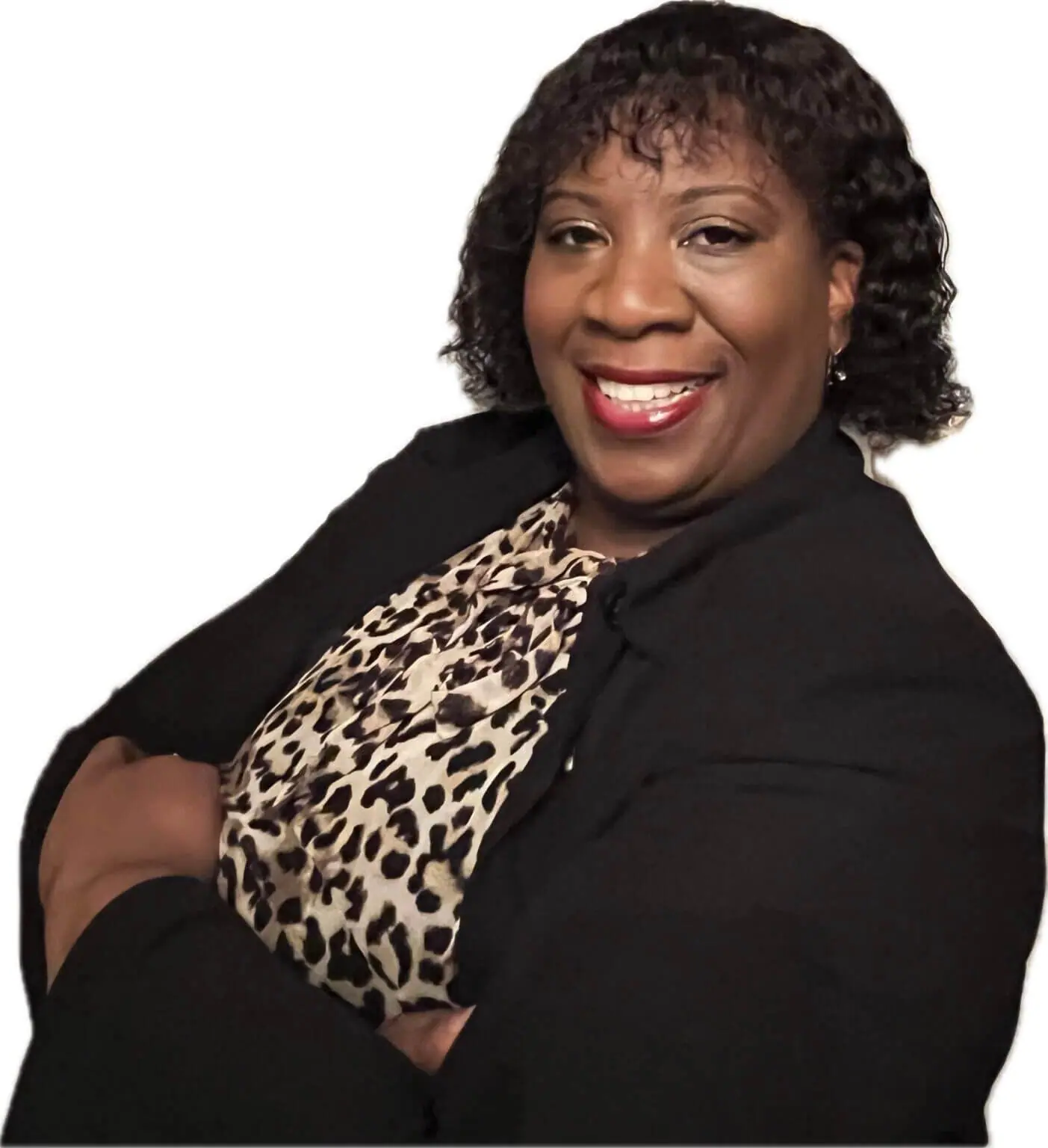 A woman wearing a black jacket and a leopard print shirt smiles for the camera