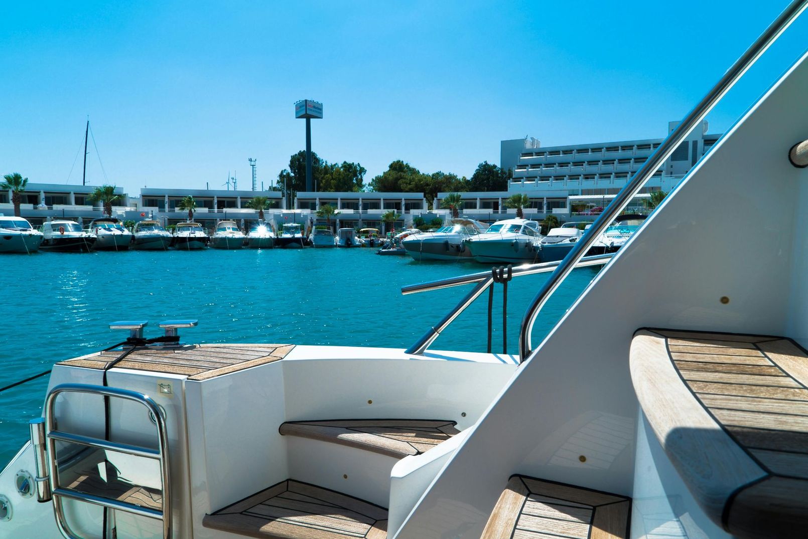 A boat is docked in a marina with a lot of boats in the water.