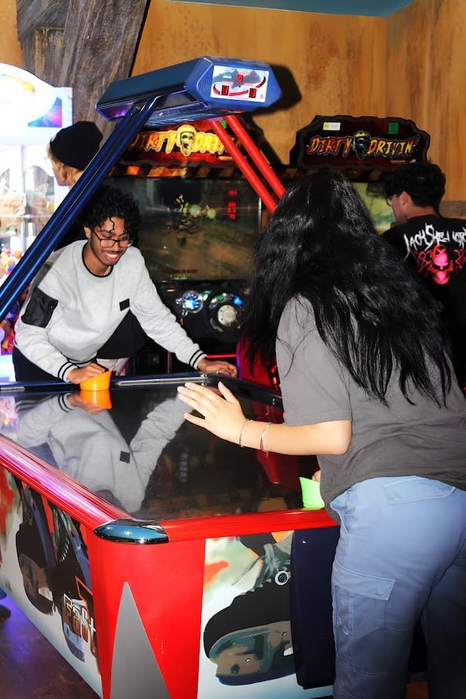 A Man and a Woman Are Playing Air Hockey in an Arcade — Gold Rush Mini Golf in Warrenheip, VIC