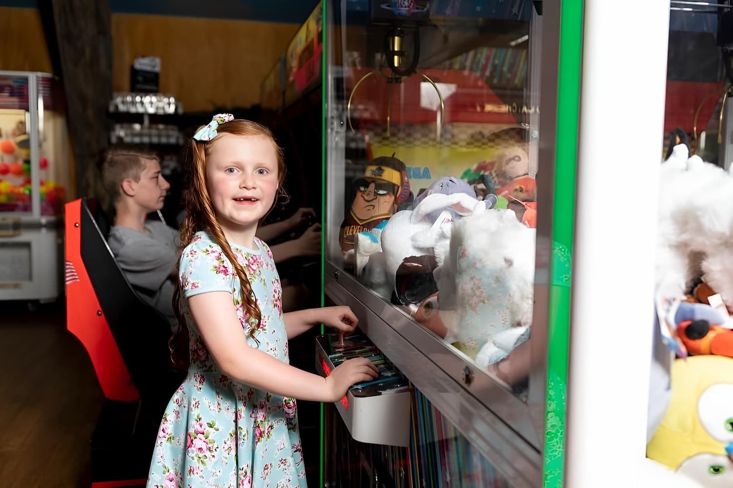 A Little Girl is Playing a Video Game in an Amusement Park — Gold Rush Mini Golf in Warrenheip, VIC