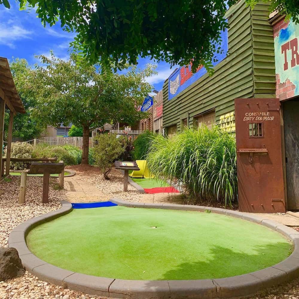 A Mini Golf Course in Front of a Building That Says Louisville — Gold Rush Mini Golf in Warrenheip, VIC