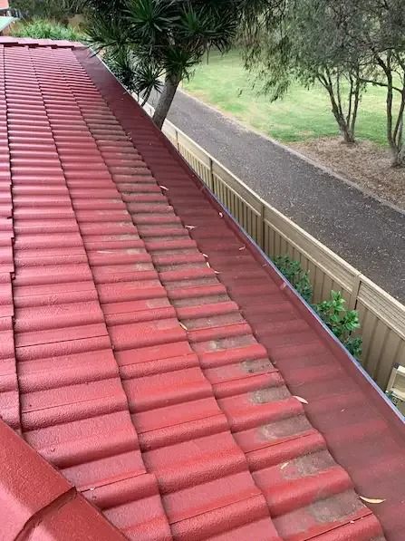 The Roof Of A House With Red Tiles And A Gutter — Gutter Guard In Lake Cathie, NSW