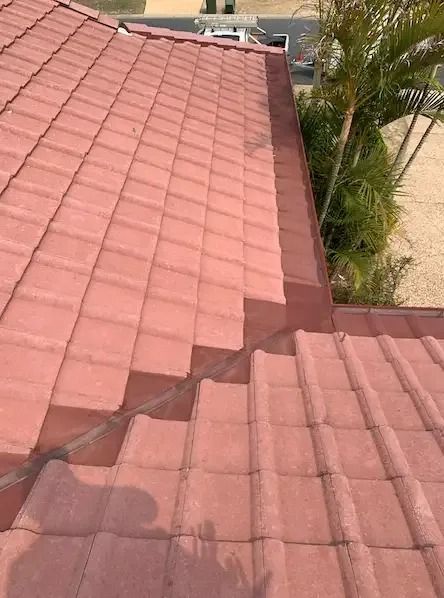 A Red Tiled Roof With A Drain On The Side Of It — Gutter Guard In Lake Cathie, NSW