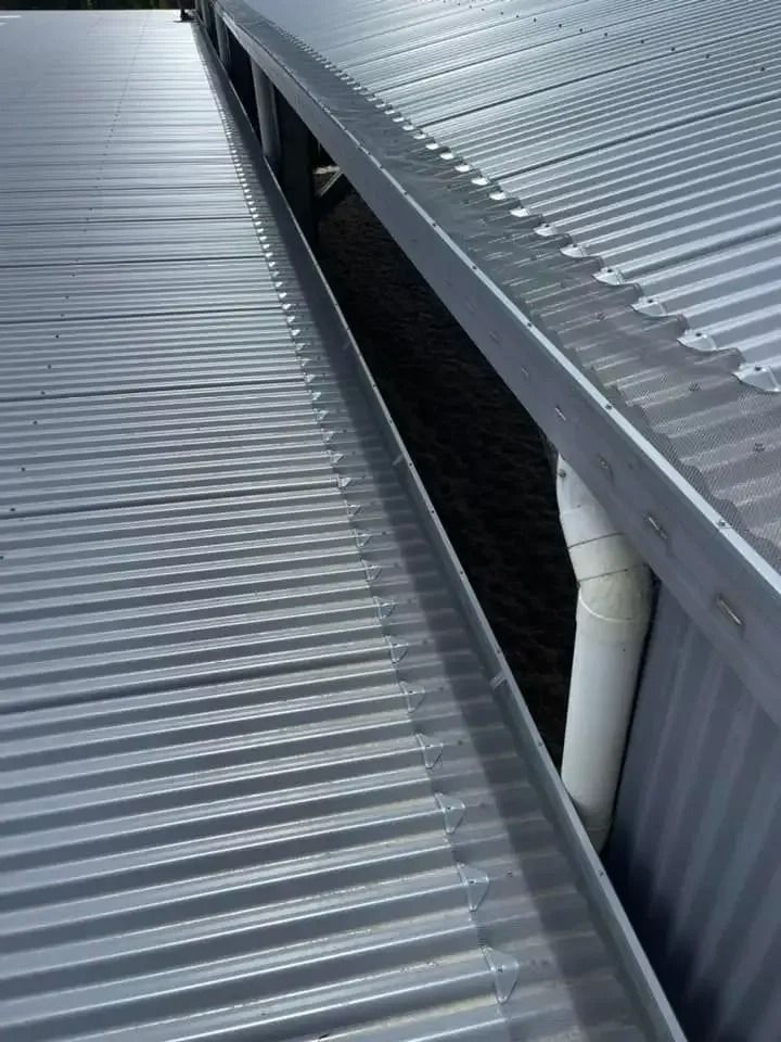 A Close Up Of A Metal Roof With A Gutter On It — Gutter Guard In Lake Cathie, NSW