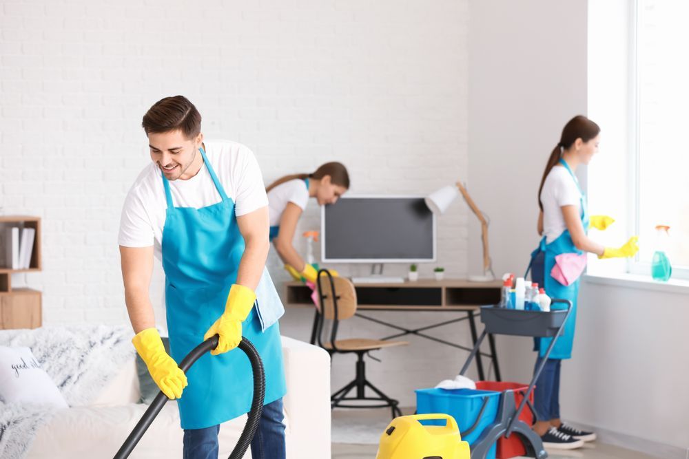 A man is using a vacuum cleaner to clean a room