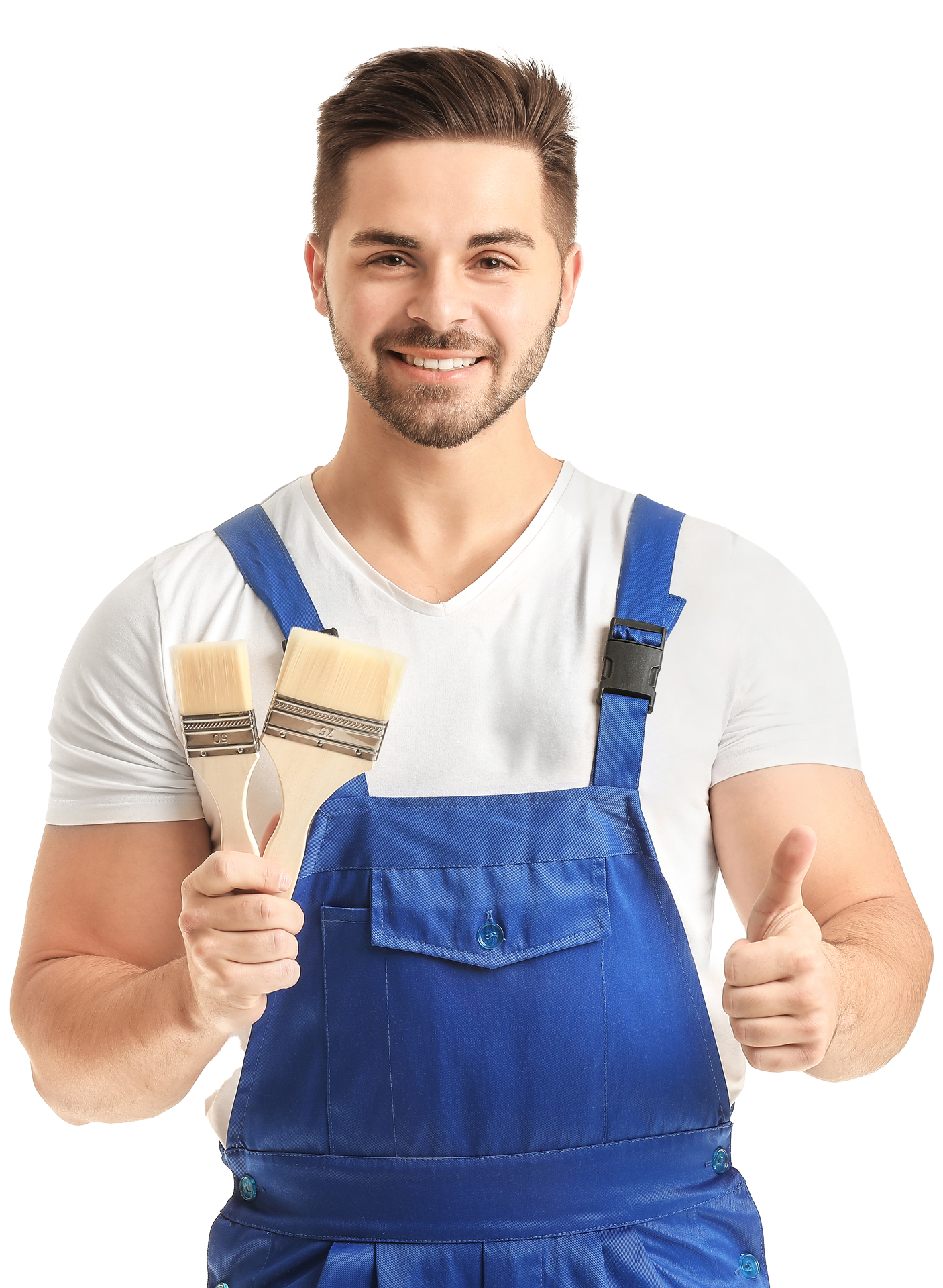 A man in blue overalls is holding two paint brushes and giving a thumbs up