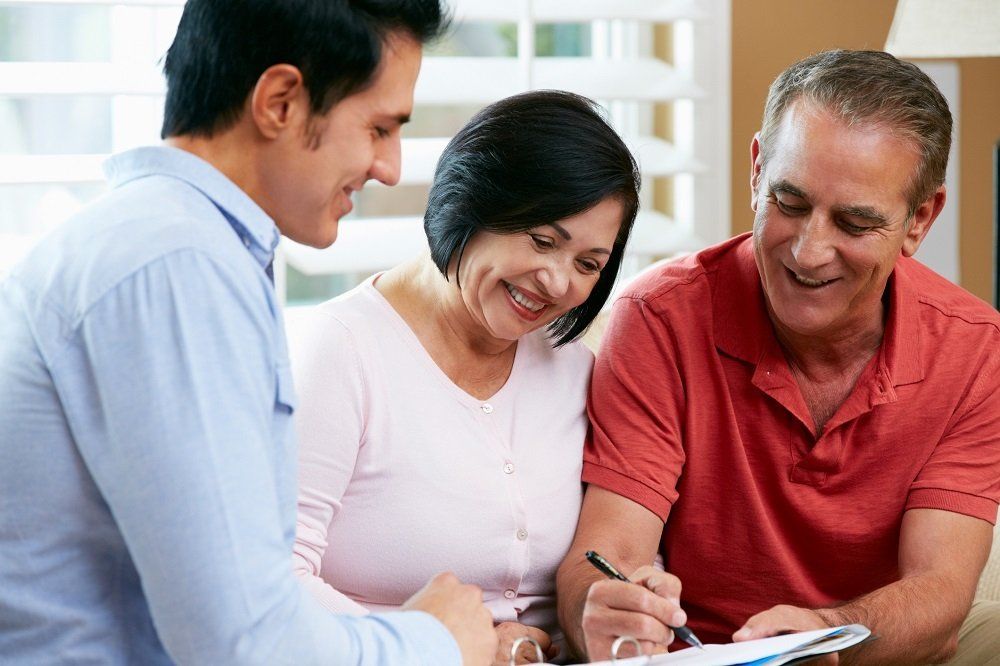 Senior Couple Signing a Document — Wausau, WI — Attorney Rhonda R Werner Schultz LLC