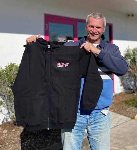 Man Holding A Black Hoodie With The Word Hip Hop On It — Accolades Awards Hunter Valley In Maitland, NSW