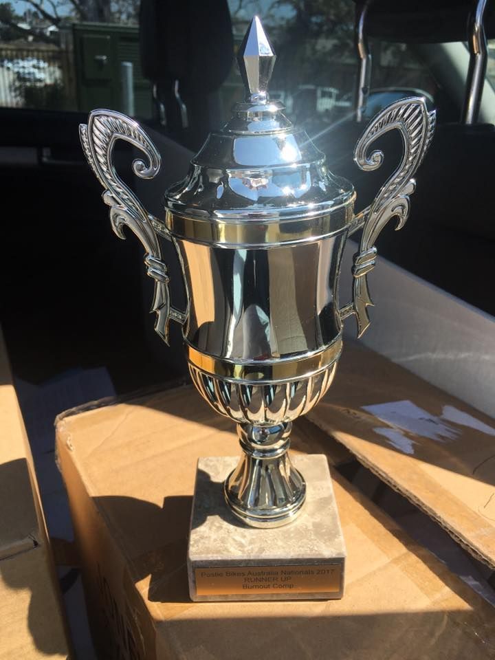 Silver Trophy On A Wooden Table — Accolades Awards Hunter Valley In Maitland, NSW