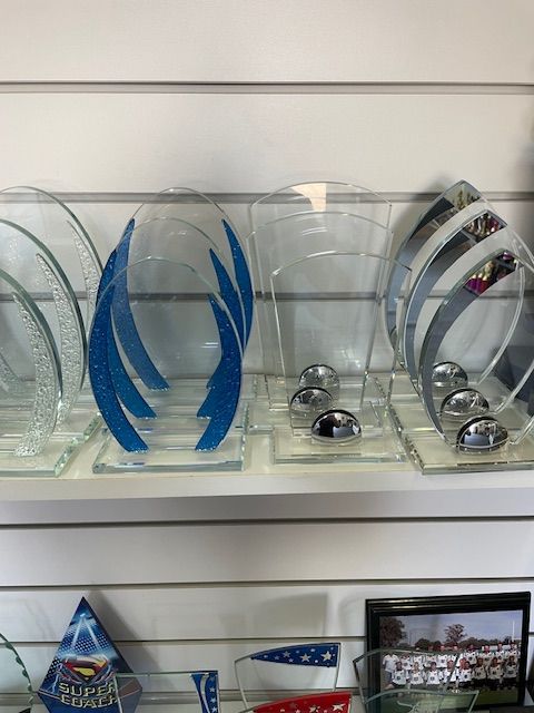 Man Standing In Front Of A Table Full Of Trophies — Accolades Awards Hunter Valley In Maitland, NSW