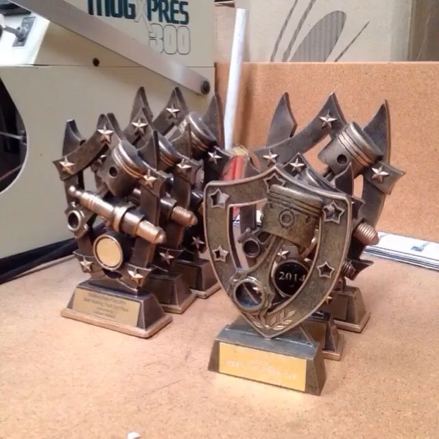 Several Trophies On A Table In Front Of A Press Machine — Accolades Awards Hunter Valley In Maitland, NSW
