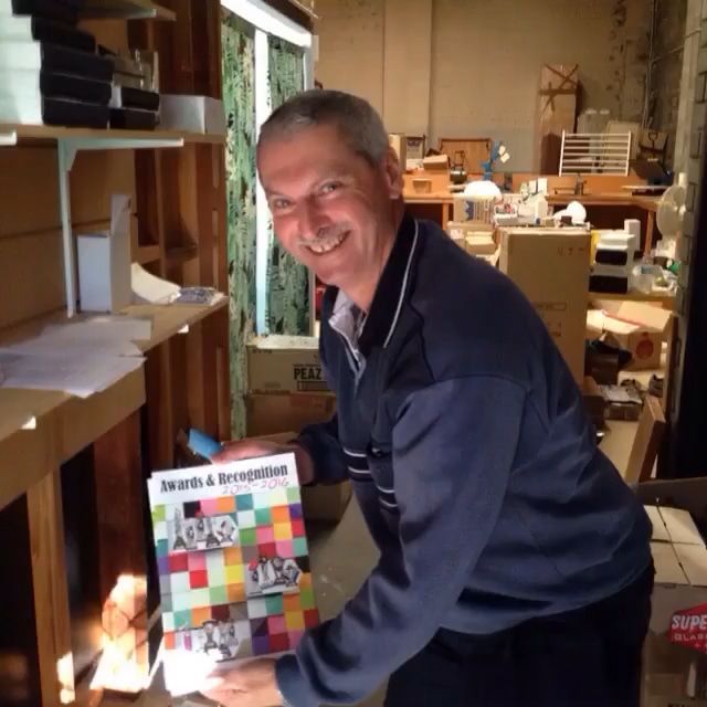 Man Holding A Book Titled Awards & Recognition — Accolades Awards Hunter Valley In Maitland, NSW
