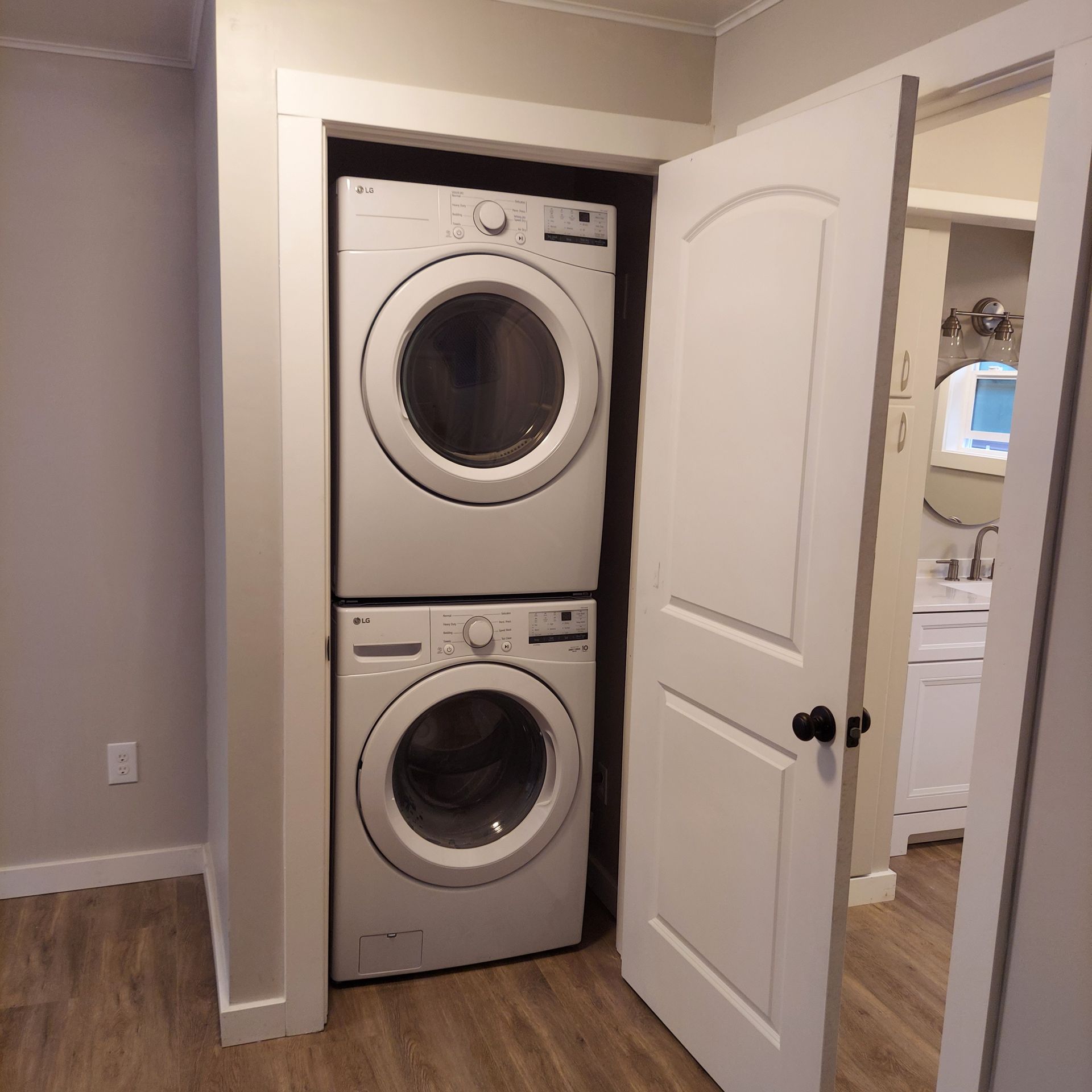 A washer and dryer are stacked on top of each other in a laundry room.