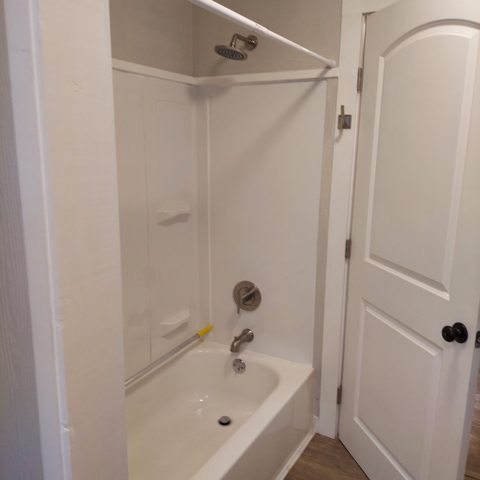 A bathroom with a bathtub and a shower.