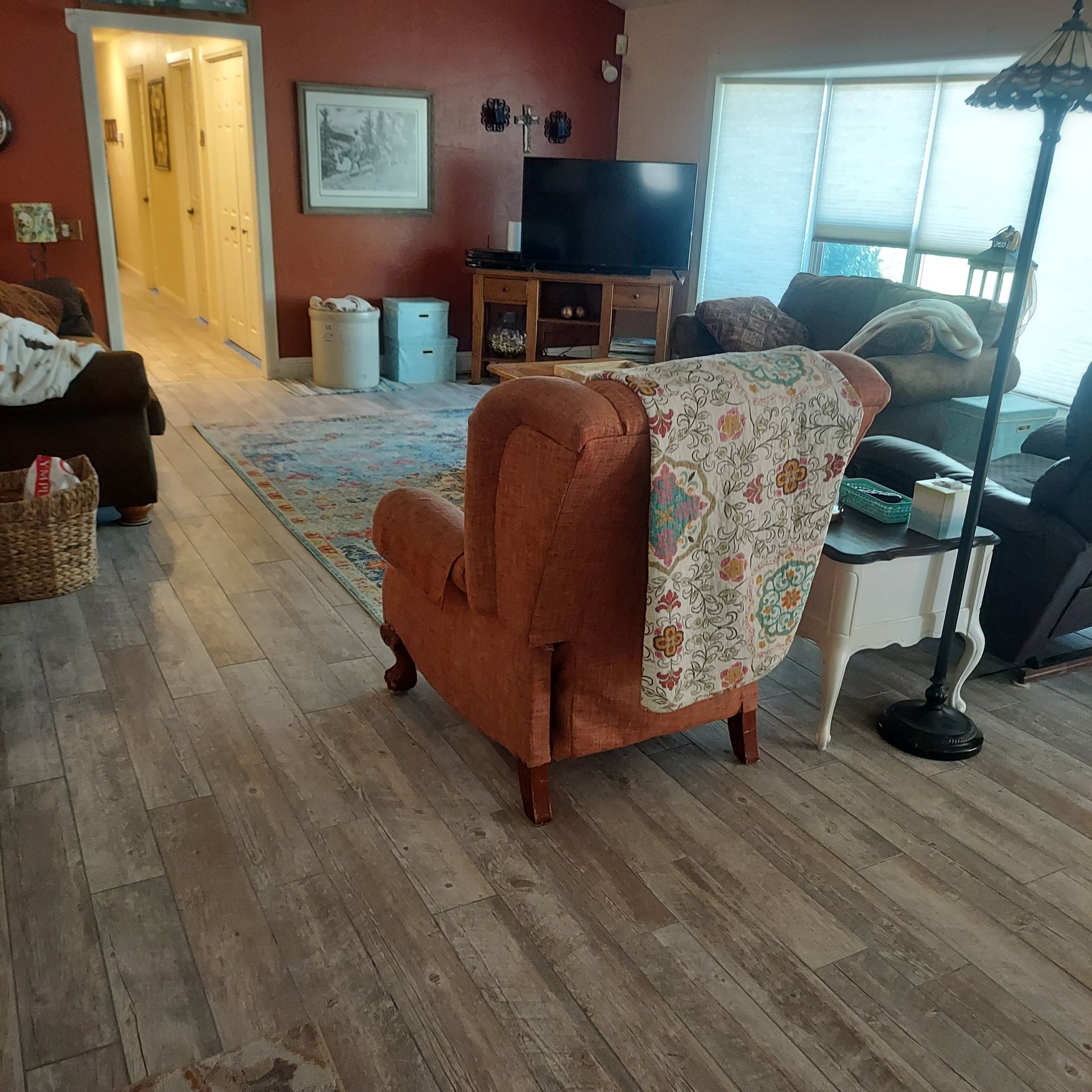A living room with a chair and a television