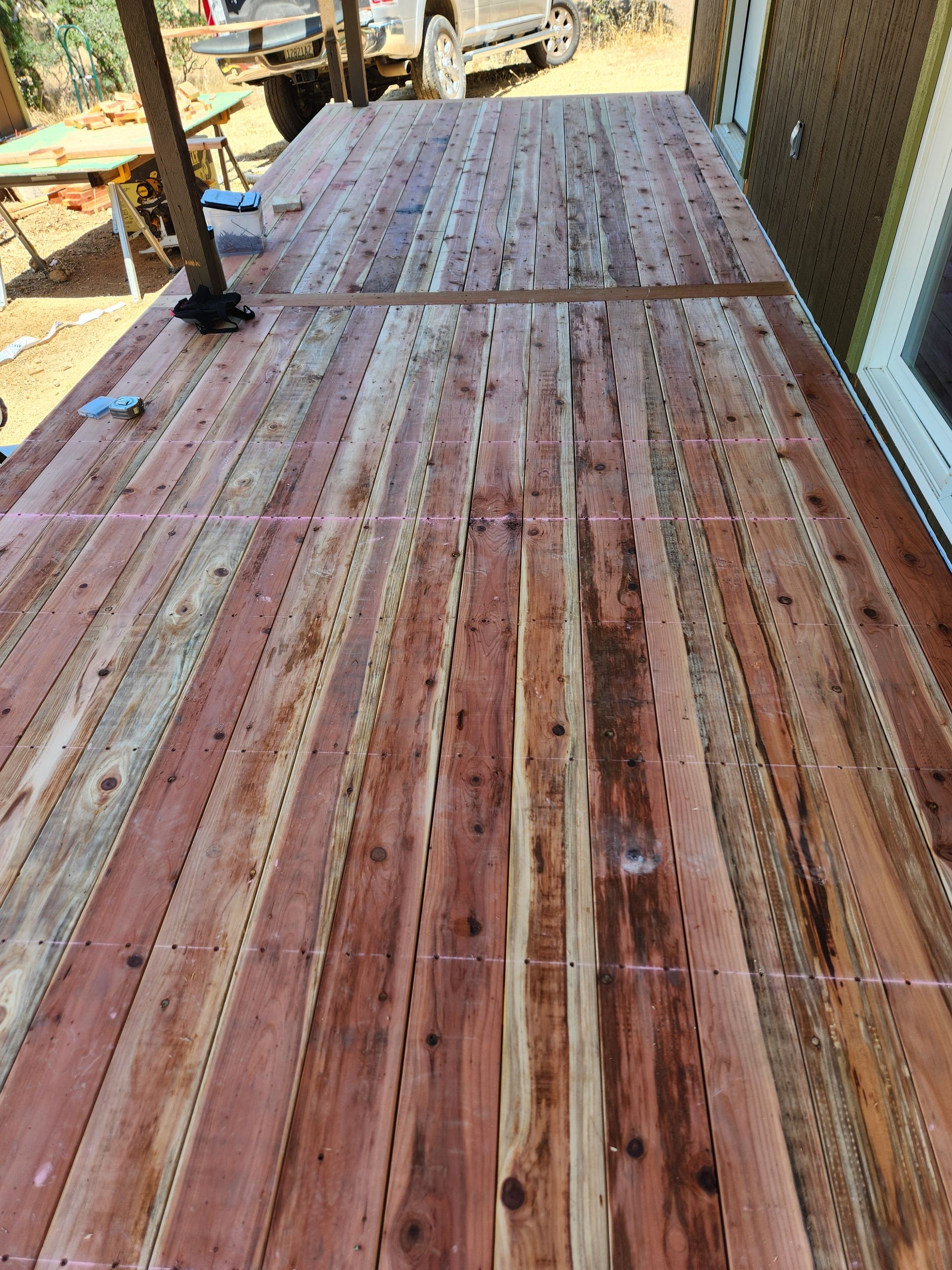 A wooden deck is being built on top of a house.