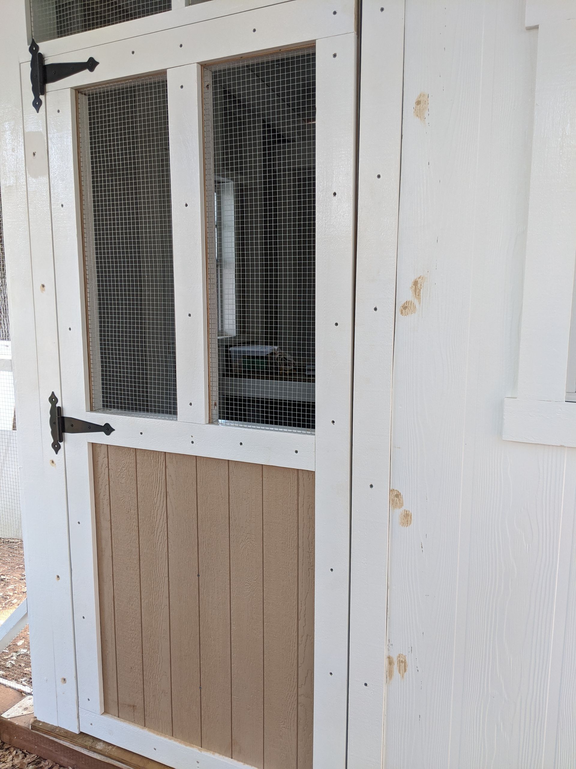 A white door with a wooden frame and a glass window