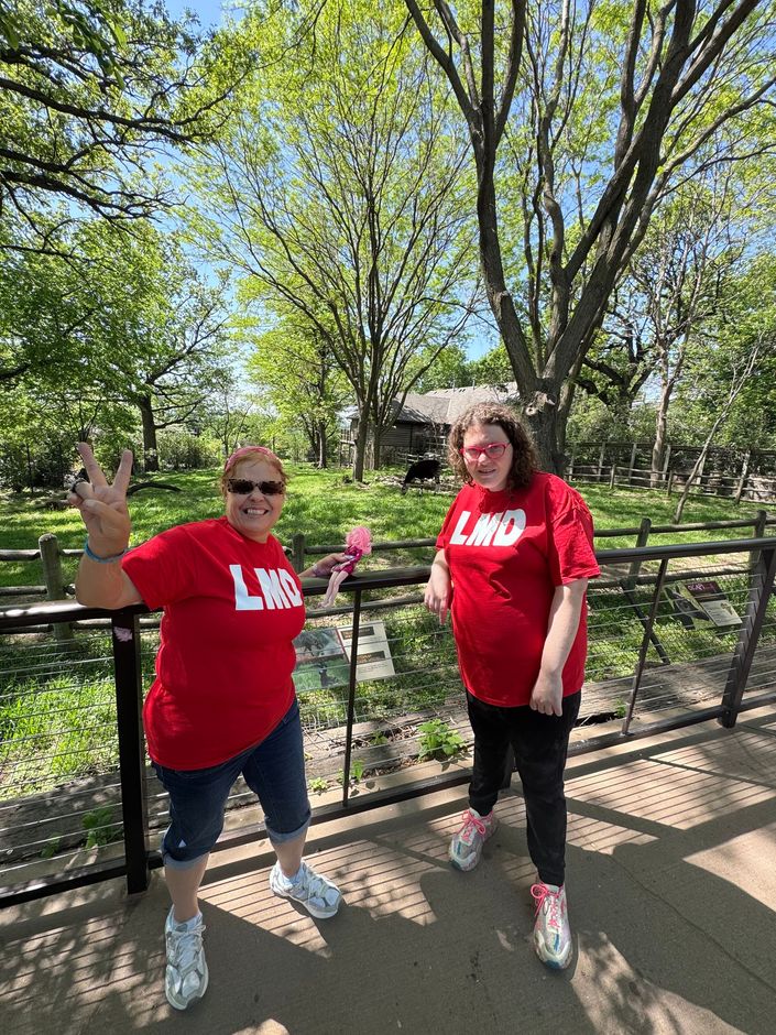 A nurse is talking to a man in a wheelchair in a waiting room.