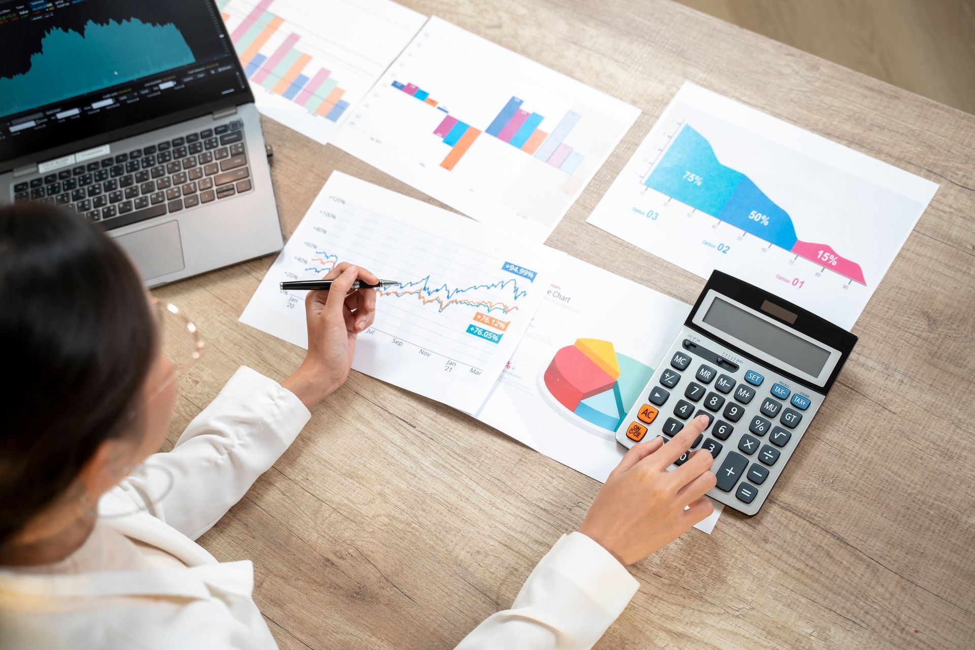 Businesswoman is calculating finances in home office.