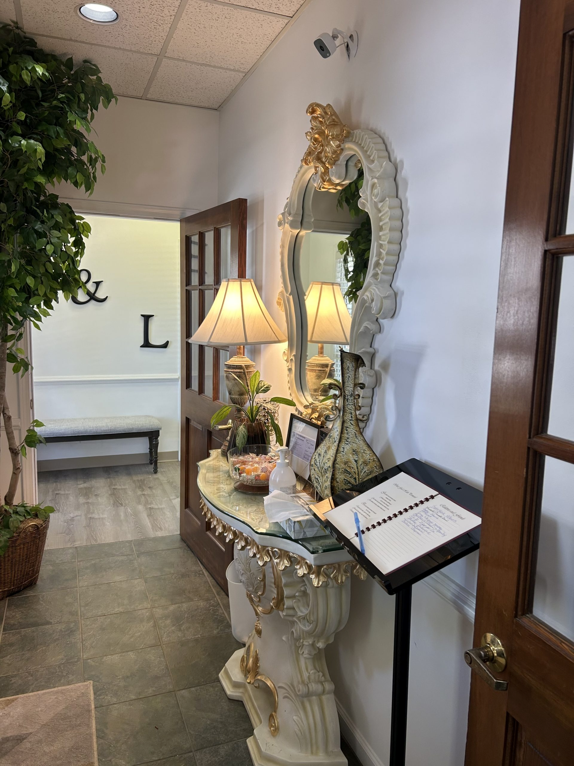 An artist 's impression of a hotel lobby with a couch , chairs , and plants.