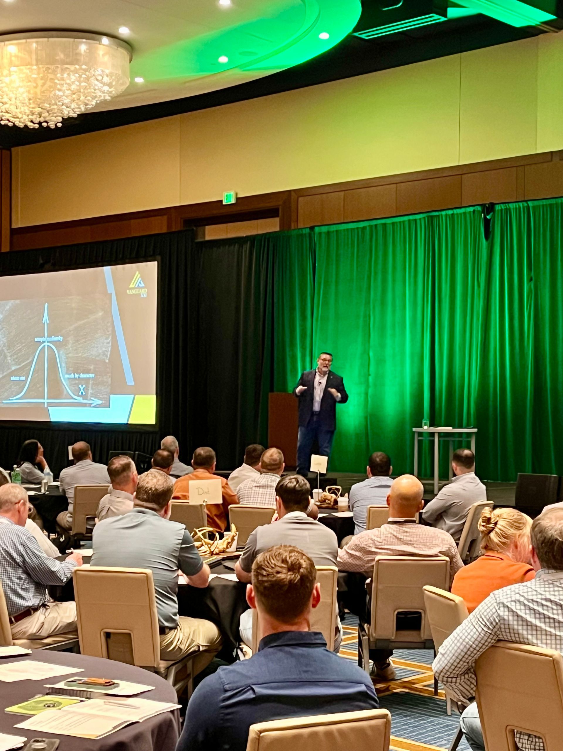 A man is giving a presentation to a group of people in a conference room.