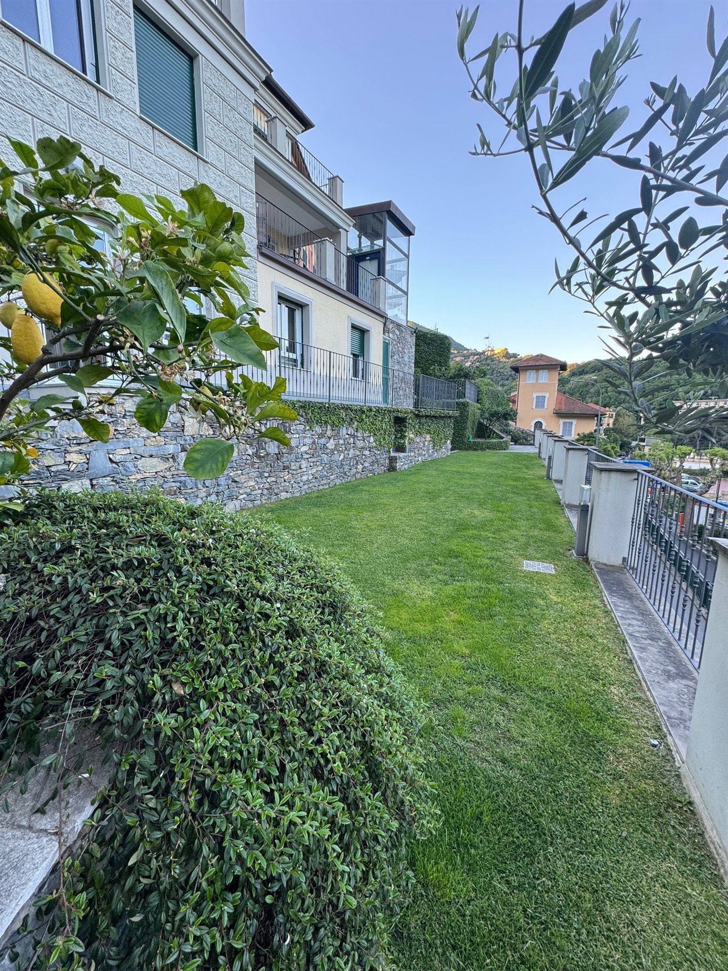 A large house with a lush green lawn in front of it.