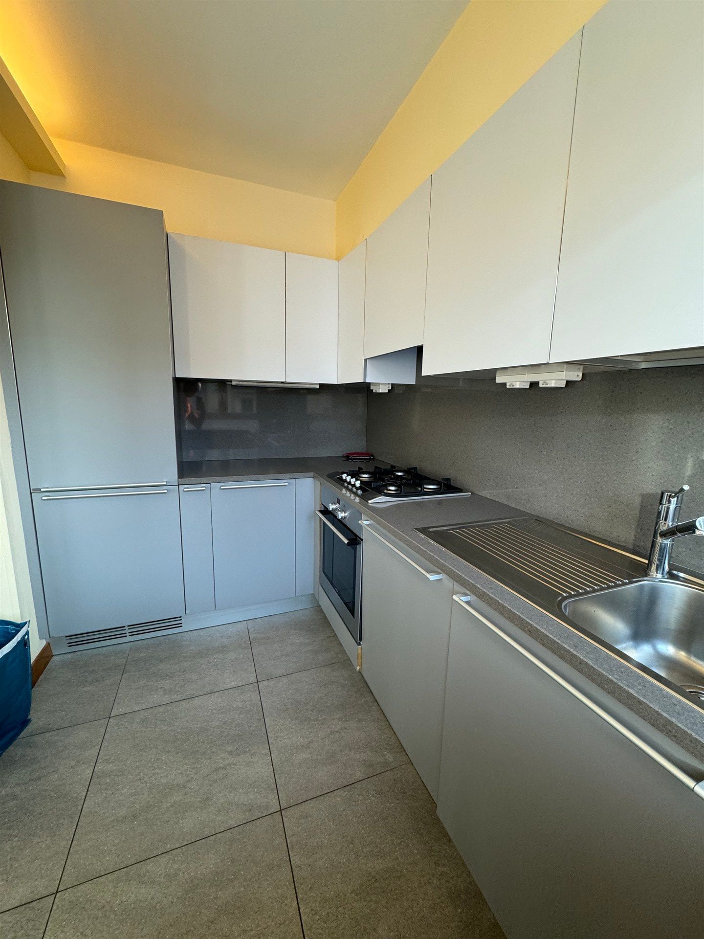A kitchen with stainless steel appliances and white cabinets