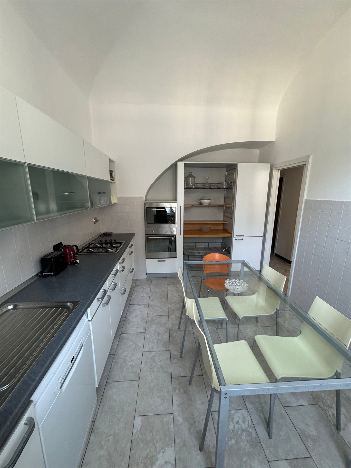 A kitchen with a table and chairs in it