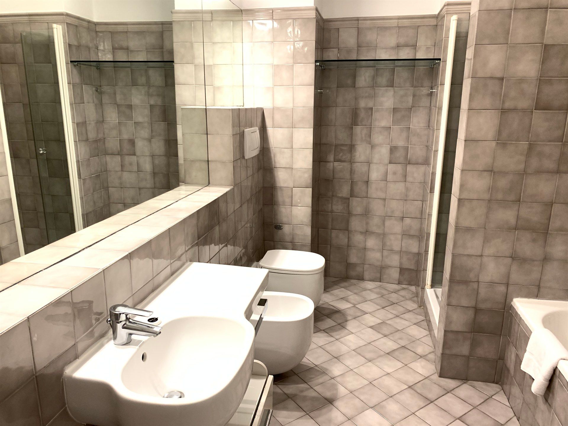 A bathroom with a sink a toilet and a shower