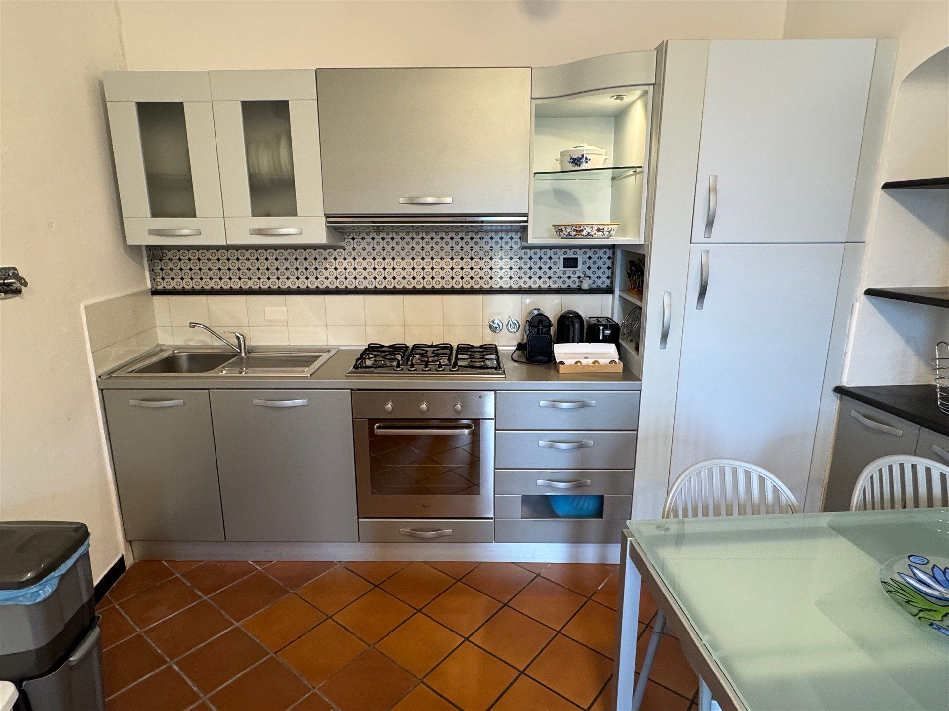 A kitchen with stainless steel appliances and white cabinets