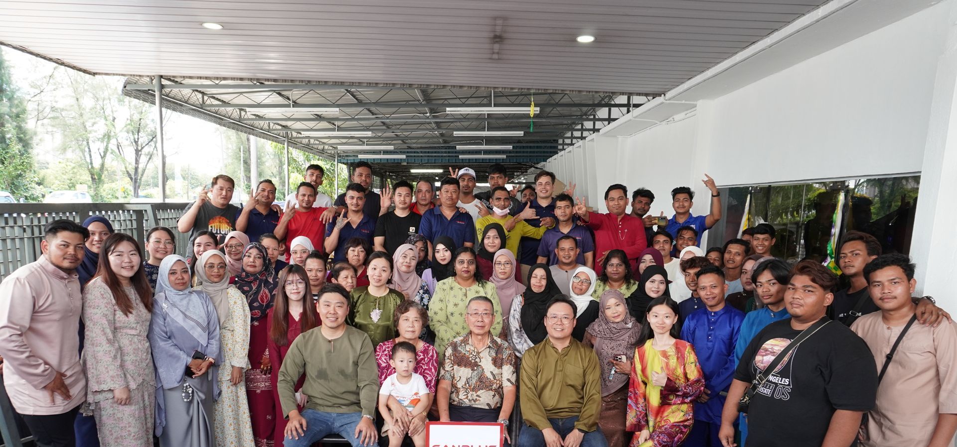 Baguss Enterprise team celebrating Hari Raya 2025 – group photo with staff dressed in traditional attire