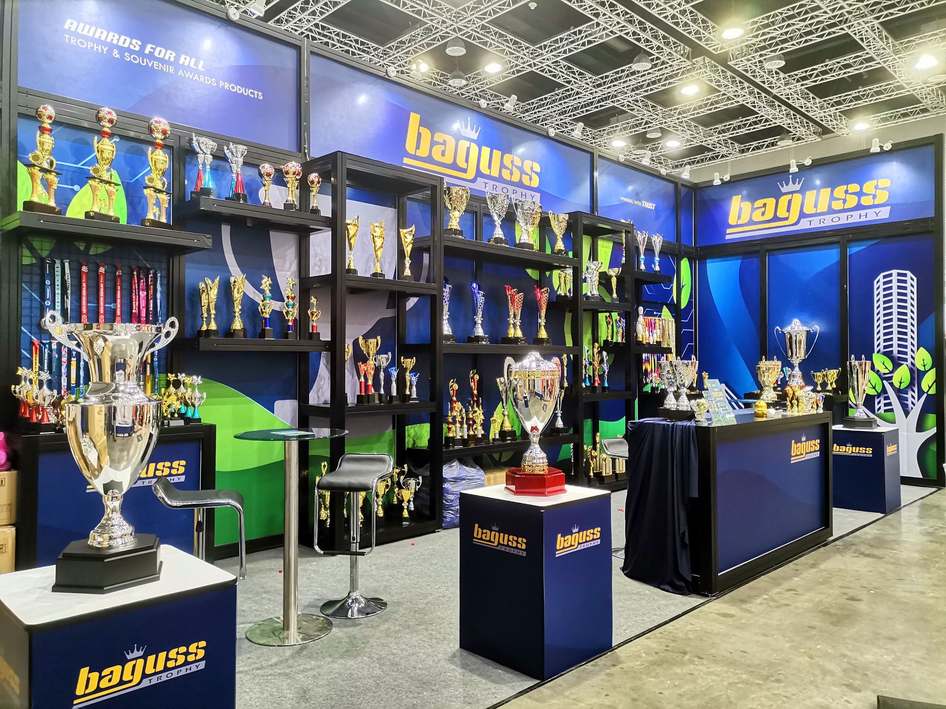 Display of custom awards, trophies, and medals at Baguss Enterprise booth during MGF 2024 exhibition in KLCC