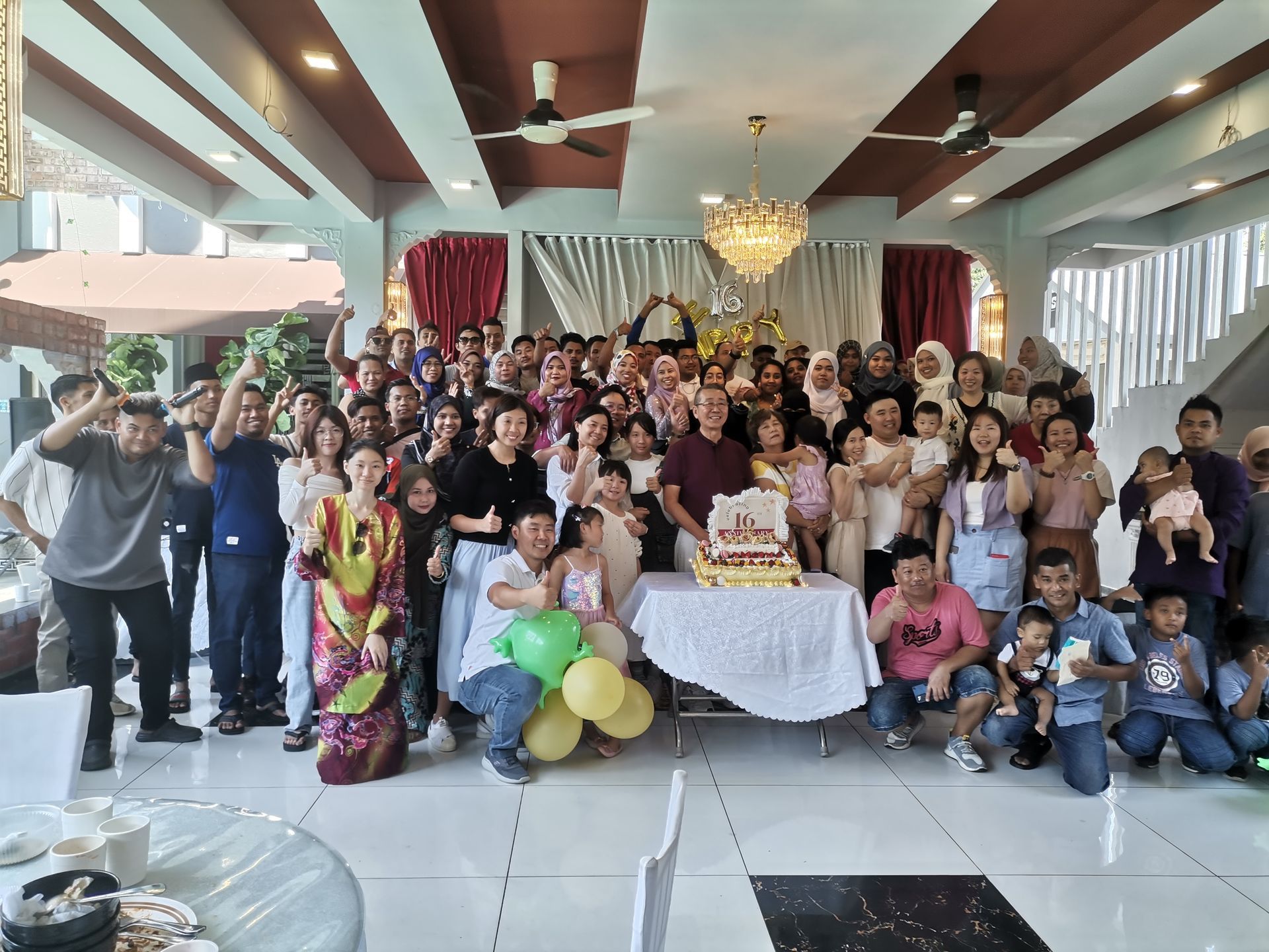 Group photo of Baguss Enterprise staff during Hari Raya 2025 celebration at The Grand Mulia.