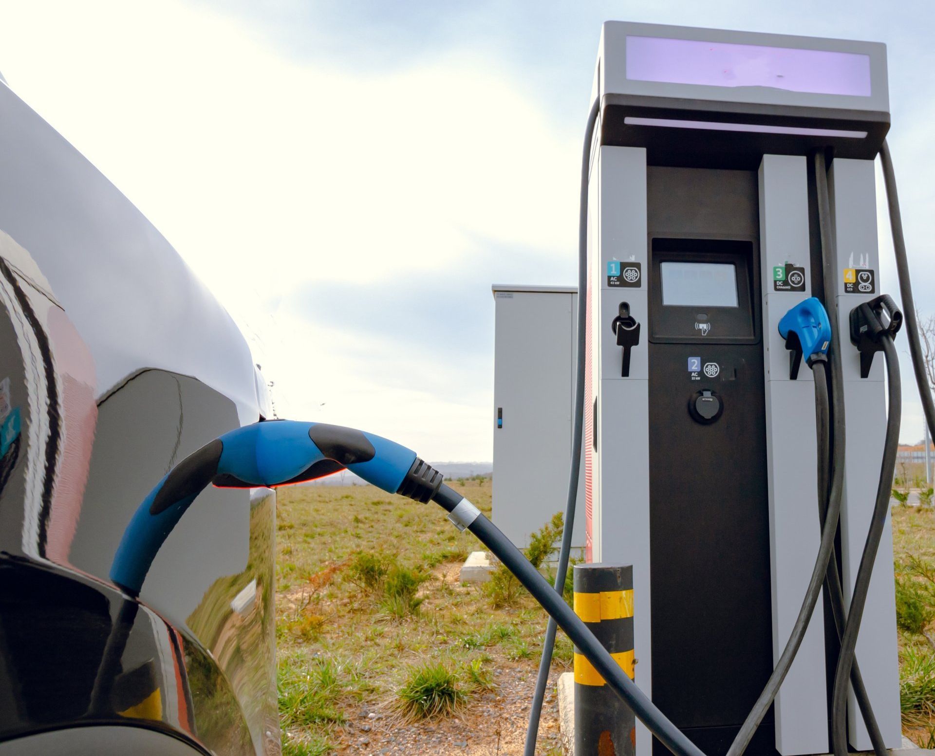 An electric car is being charged at a charging station